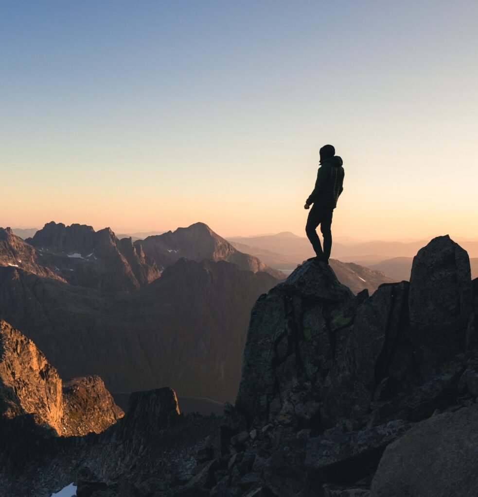 silhouette person standing top hill beautiful colorful sky morning